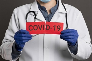 doctor ripping covid 19 card front view 23 2148445991 650x410